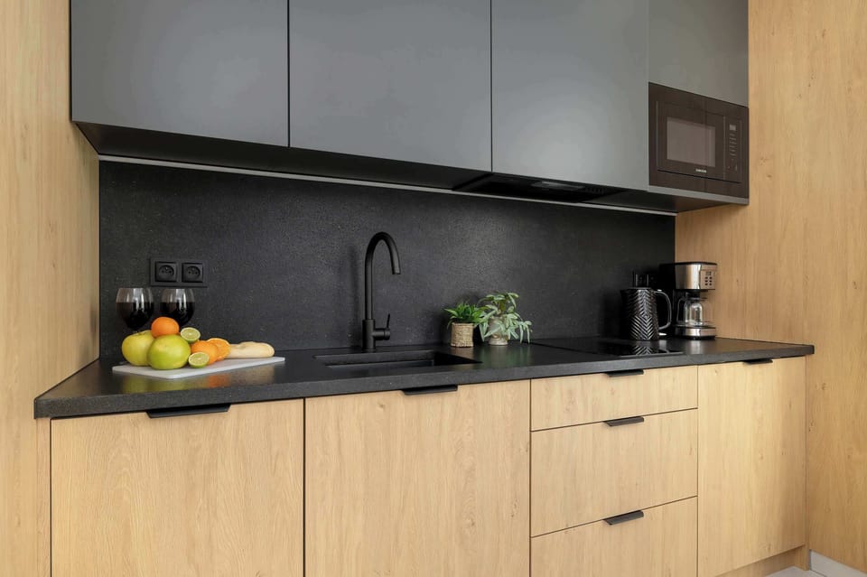 Kitchenette with plenty of kitchen utensils and dishes. 