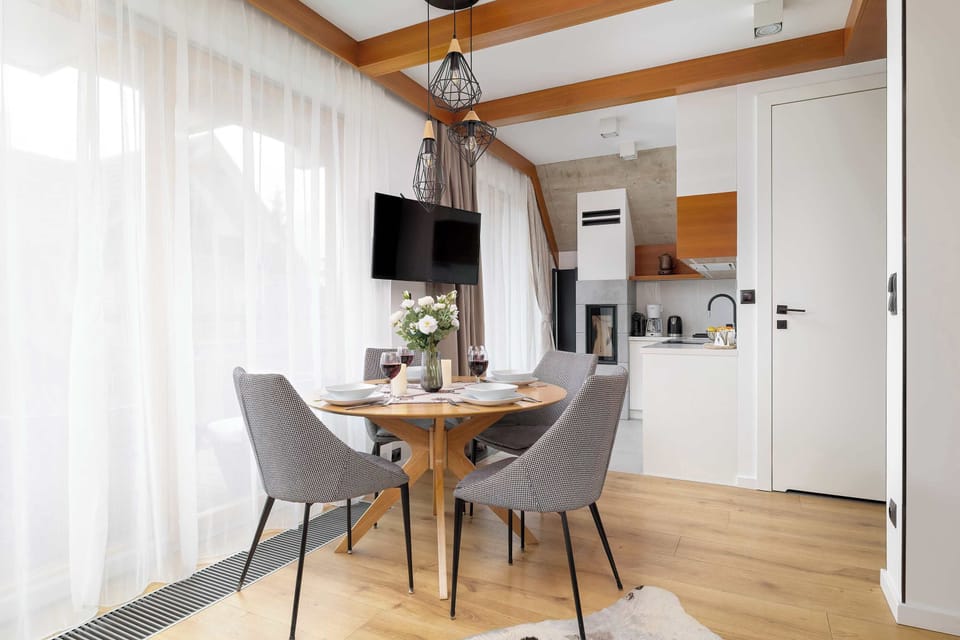 A closer perspective of the living space showing the detailed textures of furniture and a small round wooden side table.

