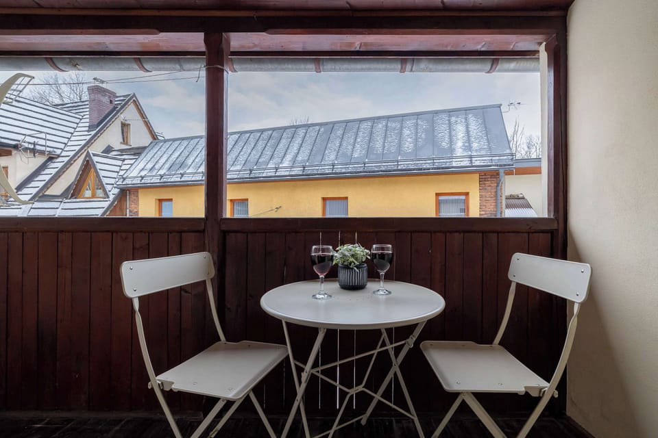A furnished balcony that provides a comfortable space to spend time outdoors.