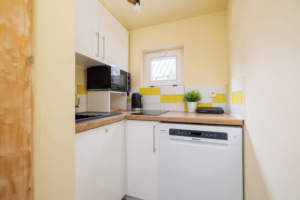 The kitchen has a dishwasher, electric kettle, microwave and hob.