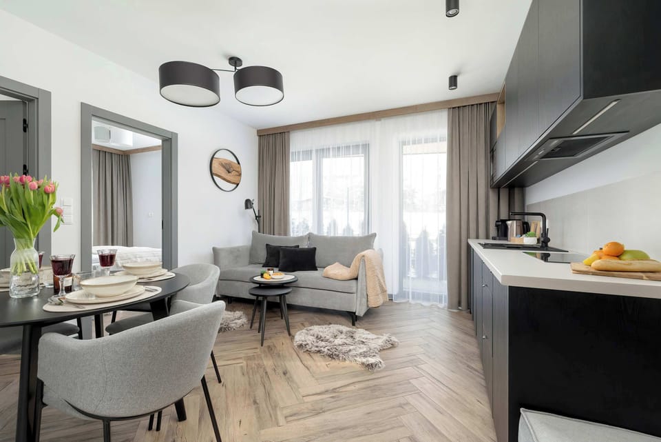 A combined dining and living area featuring contemporary furniture, soft lighting, and modern decor.