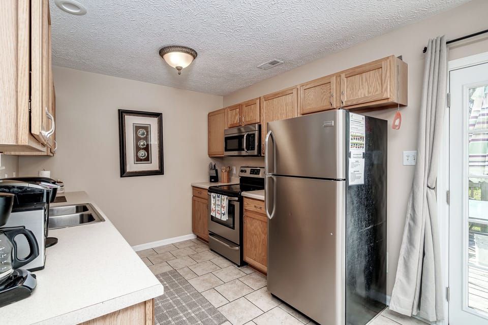 Kitchen includes refrigerator, oven, microwave, and dishwasher.