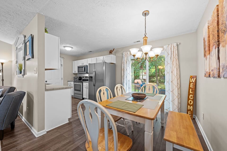 Kitchen Table with 4 Chairs and Bench. Sliding Doors lead to Patio.