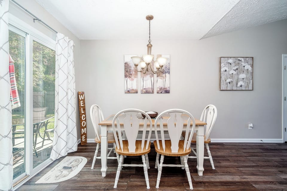 Sliding glass doors lead to back yard and patio with propane grill.