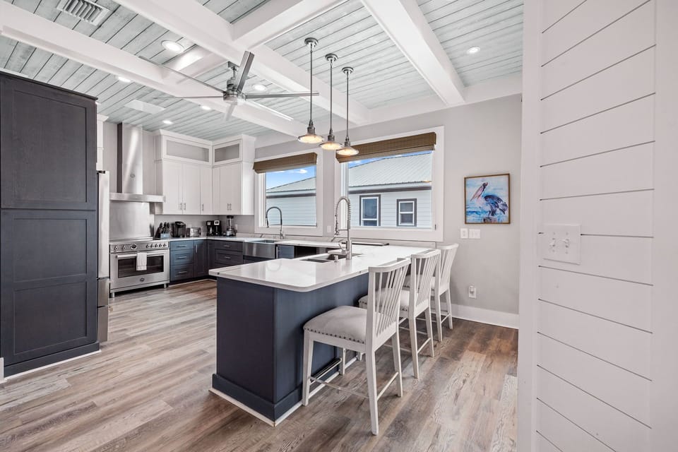 You'll love cooking in this stunning modern kitchen with sleek countertops, premium appliances, and a spacious island perfect for casual dining.