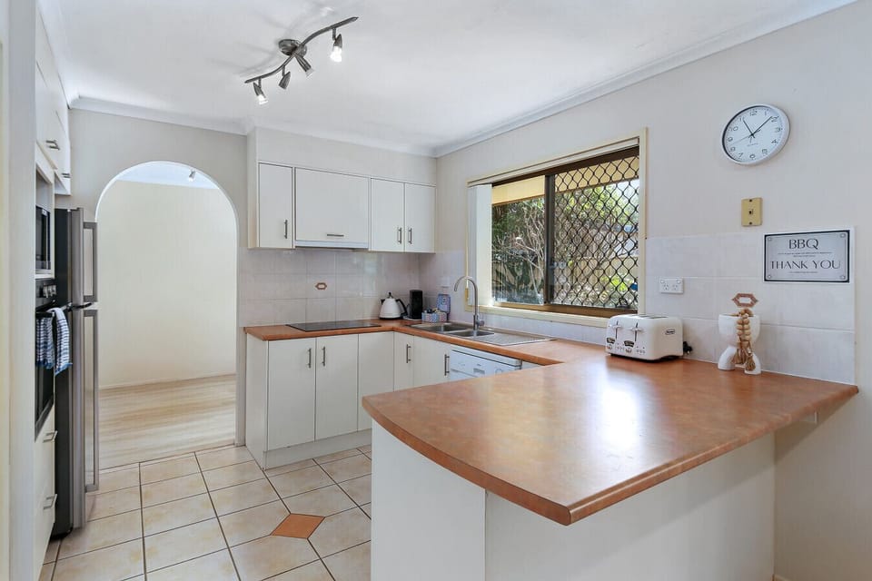 Cook up a storm in the fully equipped kitchen with family size fridge, microwave, oven, cook top and dishwasher while enjoying the garden views from the window.
