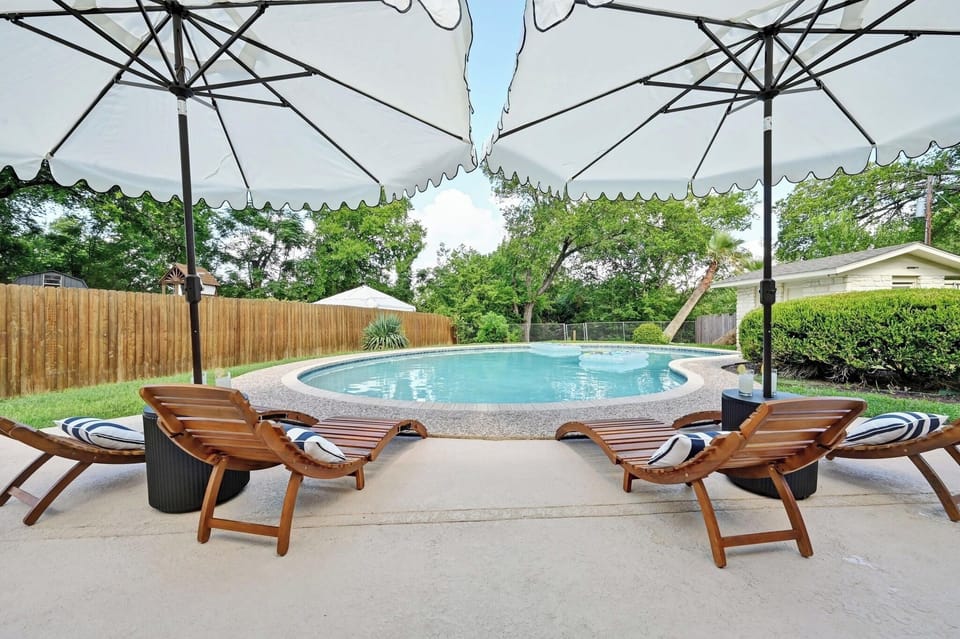 Fully fenced, resort-style backyard featuring a large private pool