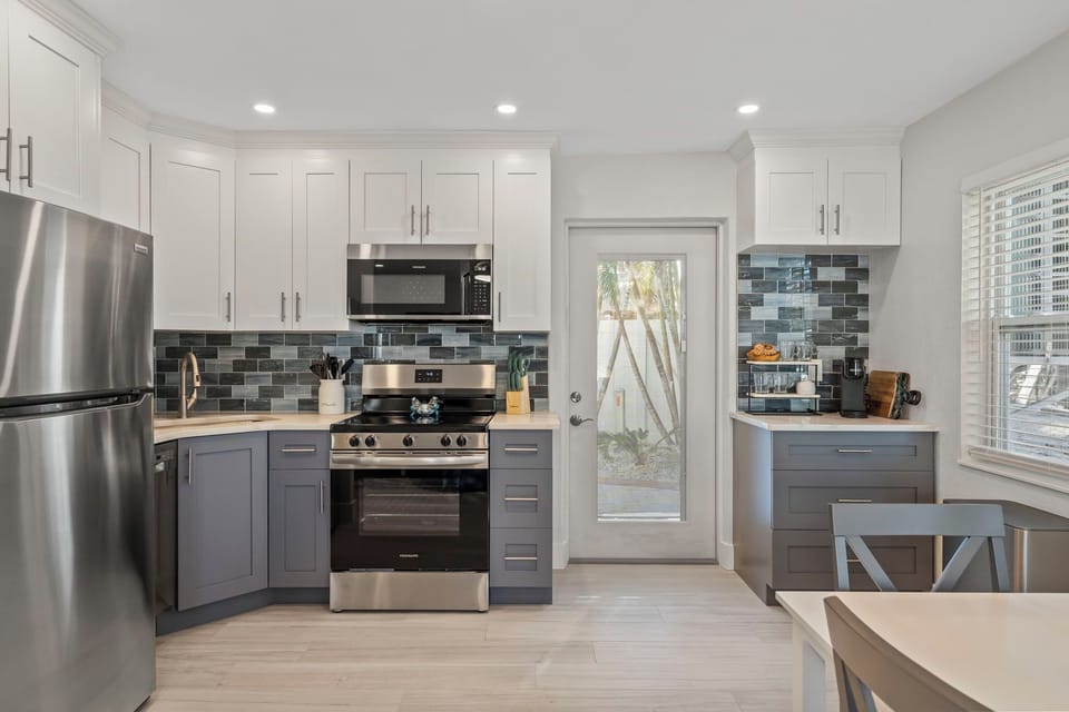 Full Kitchen and coffee bar, door to back patio.