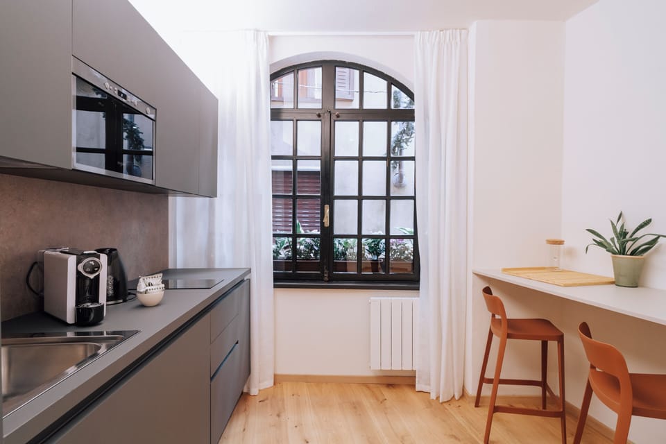 Standard Apartment | Living area | 32-inch flat-screen TV with satellite channels