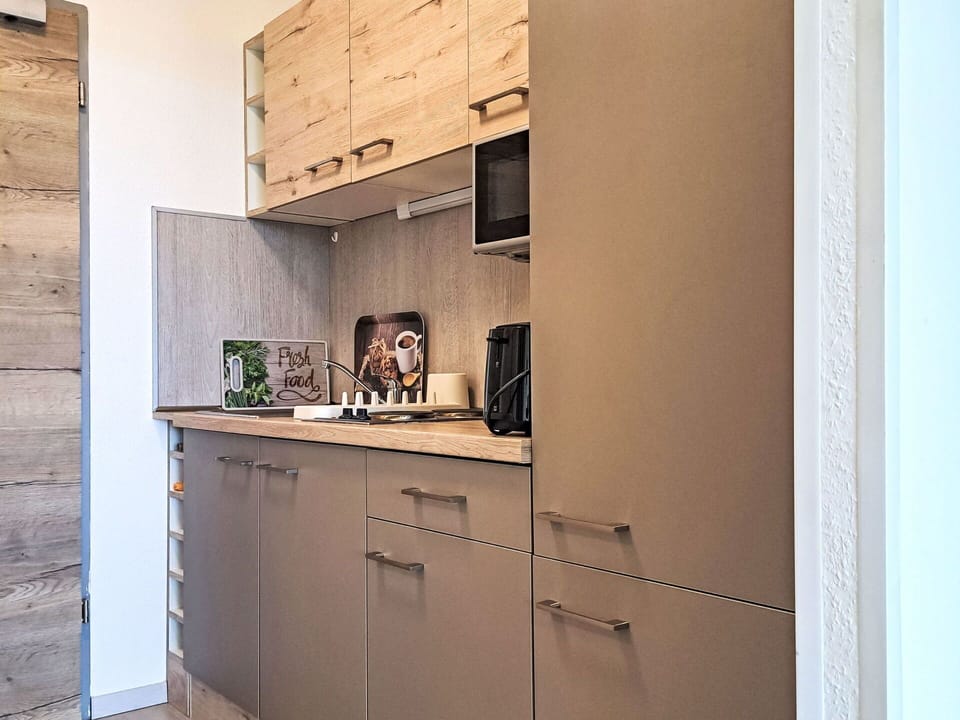 Kitchen, Countertop, Kitchen Appliance, Cabinetry, Furniture, Interior Design, Wood, Major Appliance, Flooring, Home Appliance