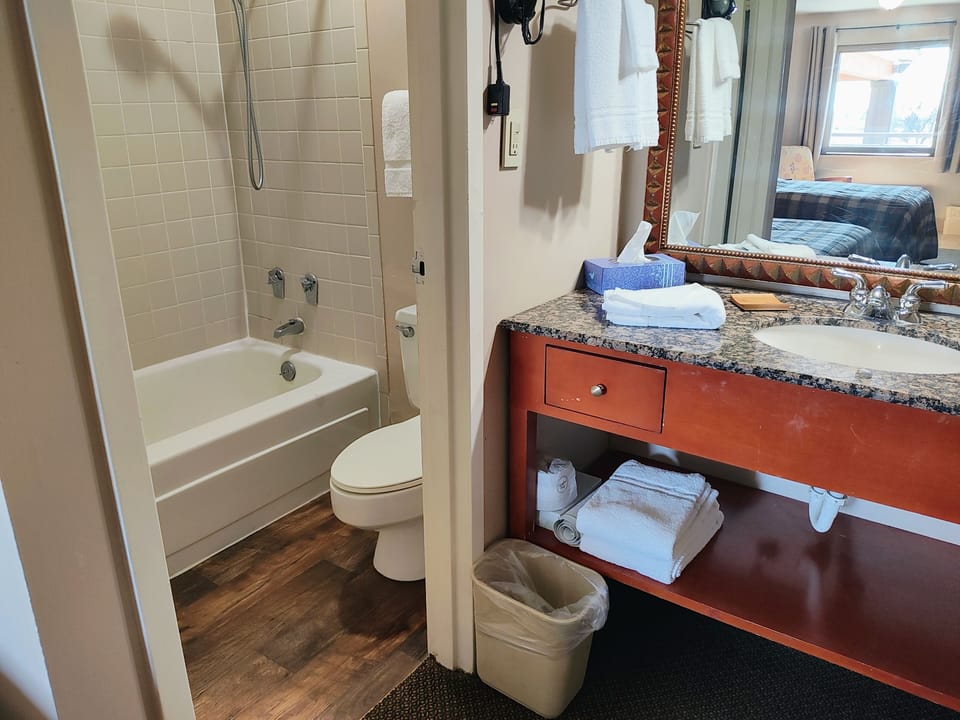 Economy Double Room, 2 Double Beds | Bathroom | Combined shower/tub, free toiletries, hair dryer, towels