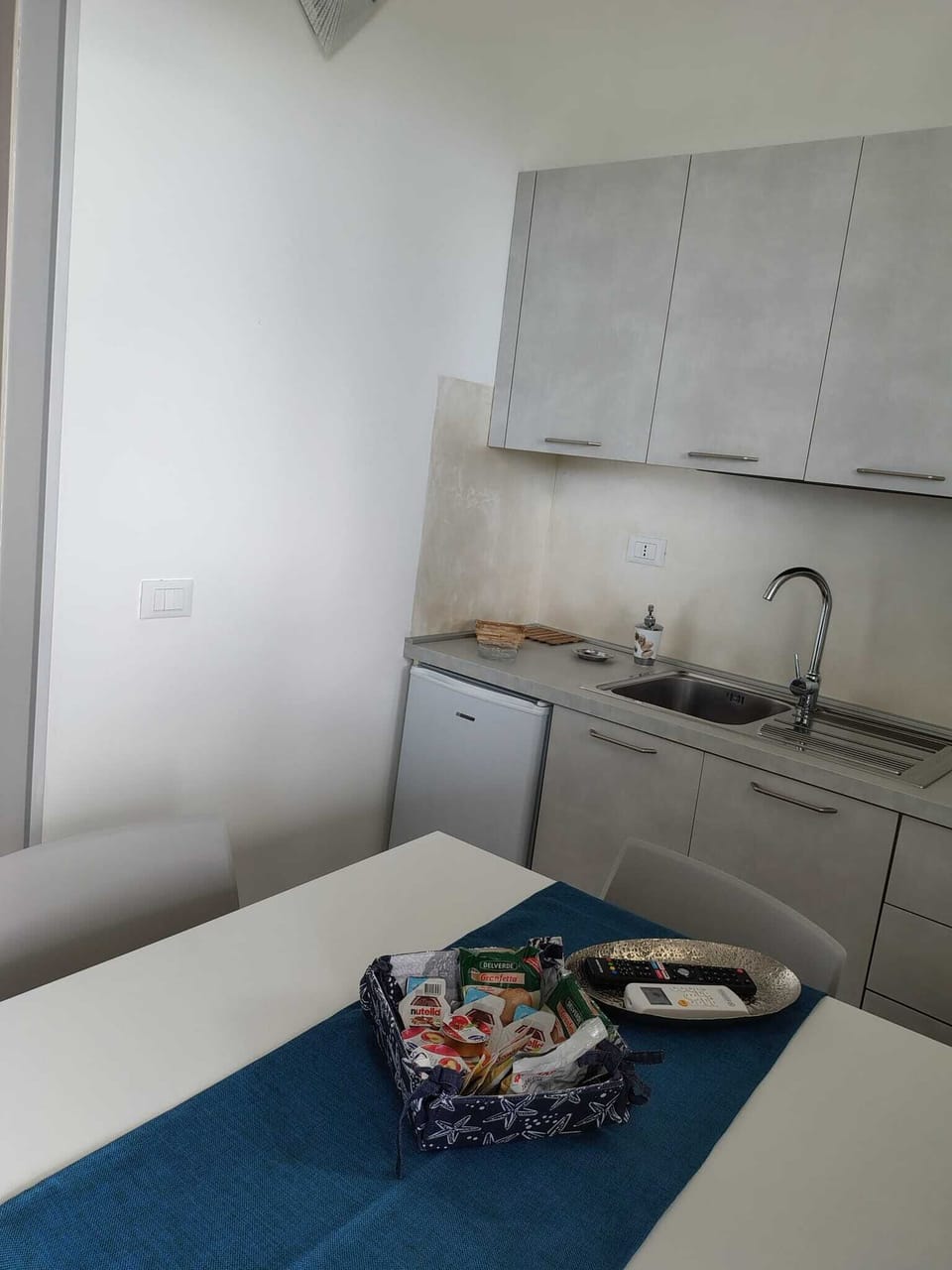 Full-size fridge, stovetop, electric kettle, cookware/dishes/utensils