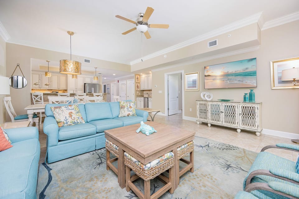 Cozy up with loved ones in the spacious living area, enjoying the beach decor and a family movie night