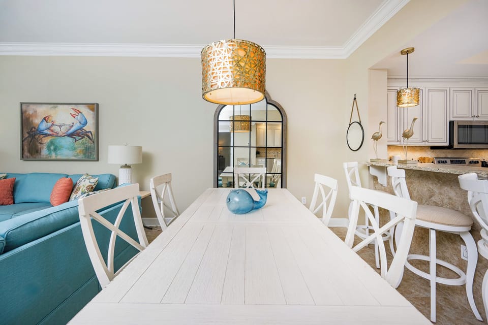 Gather around the elegant dining table, enveloped in warmth, perfect for family meals after a day at the coast