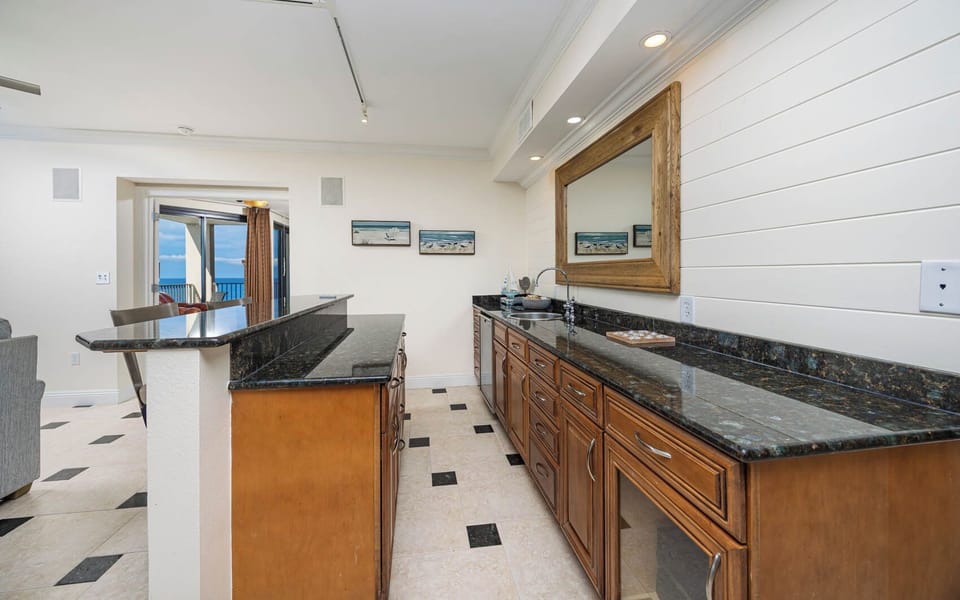 Gather around the bar for a night of entertaining to prepare drinks from the wet bar with a wine cooler and stereo station