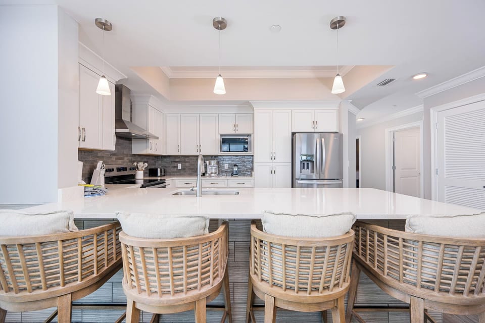 Gather around the stylish breakfast bar with comfortable seating, perfect for morning coffee