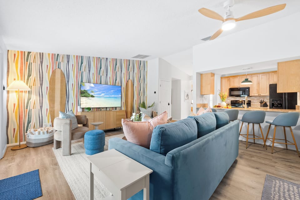 Spacious & welcoming living area with cozy seating & a smart TV for movie nights