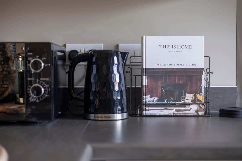 Cook up your favorite meals in our fully equipped, stylish kitchen featuring an oven, stove, microwave, refrigerator, and washing machine. This modern space has everything you need for a comfortable stay.