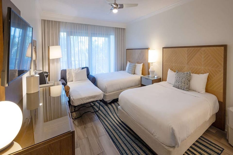 Unwind in this comfortable room featuring two queen beds and a twin-size pull-out sleeper chair.