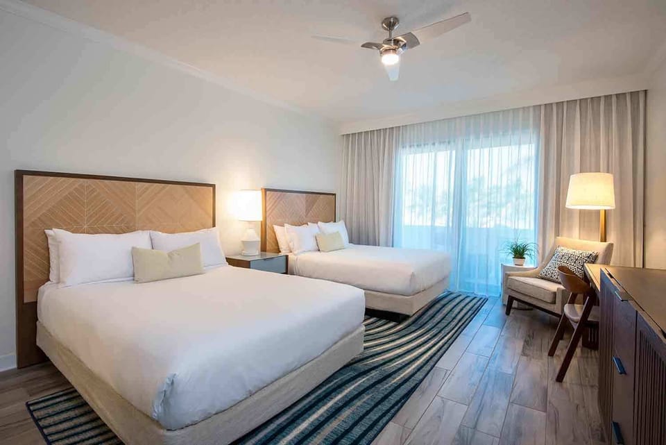 Ease into island rhythm in a spacious retreat where breezy curtains, natural tones, and cozy textures welcome you in.