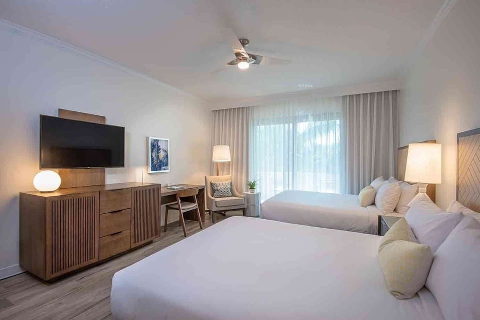 Unwind in a spacious, sunlit room where soft tones and cozy textures invite total relaxation.