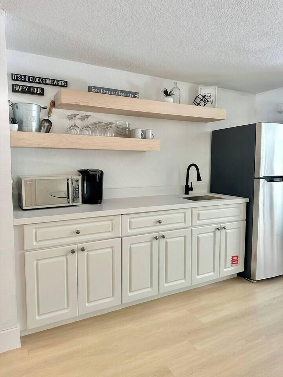 Guest suite kitchenette with fridge, coffee maker, and essentials for easy snacking or sipping.