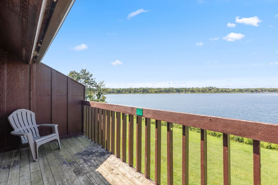 Balcony seating with peaceful views of the sparkling lake.