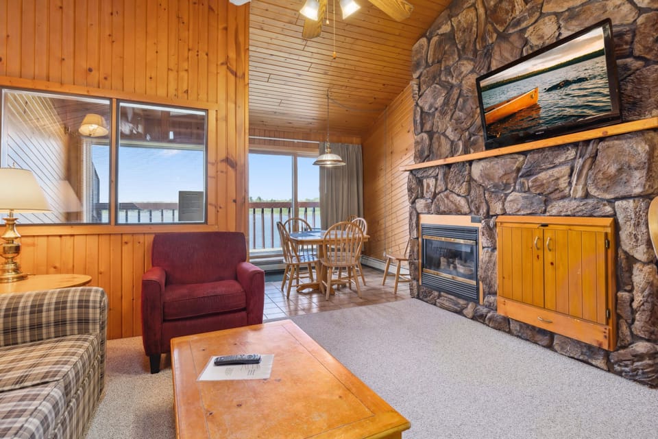 Cozy living room with stone fireplace and plush seating.