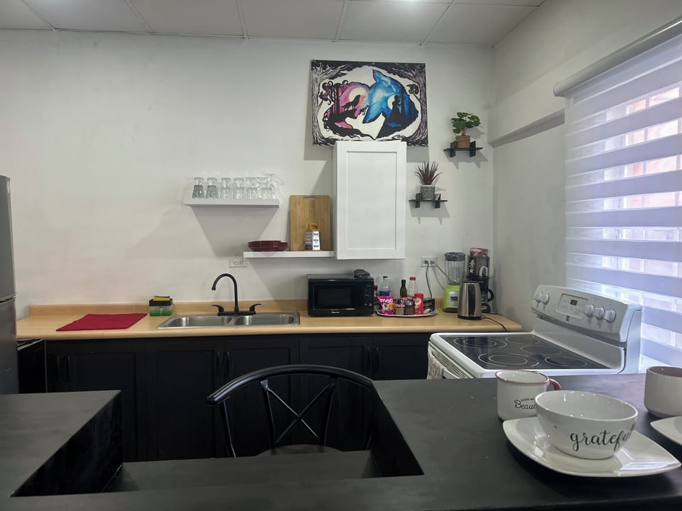 Kitchen outfitted with cooking utensils and flatware