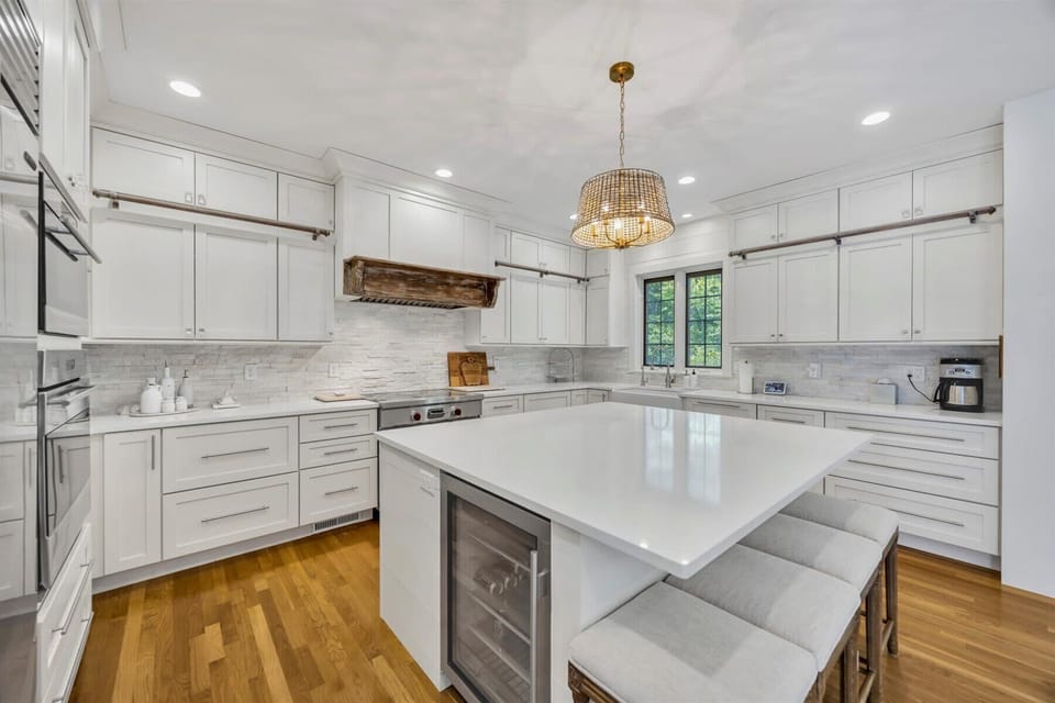 From the custom range hood to the built-in wine fridge, every detail in this kitchen is crafted for both style and function.