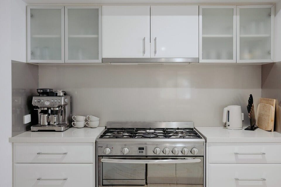 Brew up barista-style coffee with the espresso machine and cook up a feast on the 6-burner gas stove in this well-appointed kitchen setup.