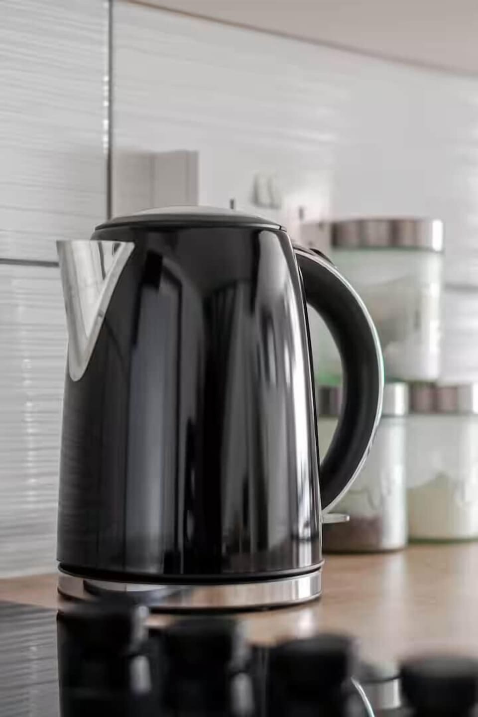 Kettle with sugar, coffee and tea amenities, convenient for short stays.