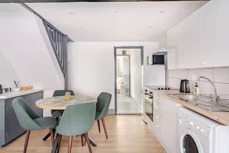 Family dining table in the kitchen, seating everyone comfortably for breakfast or dinner.