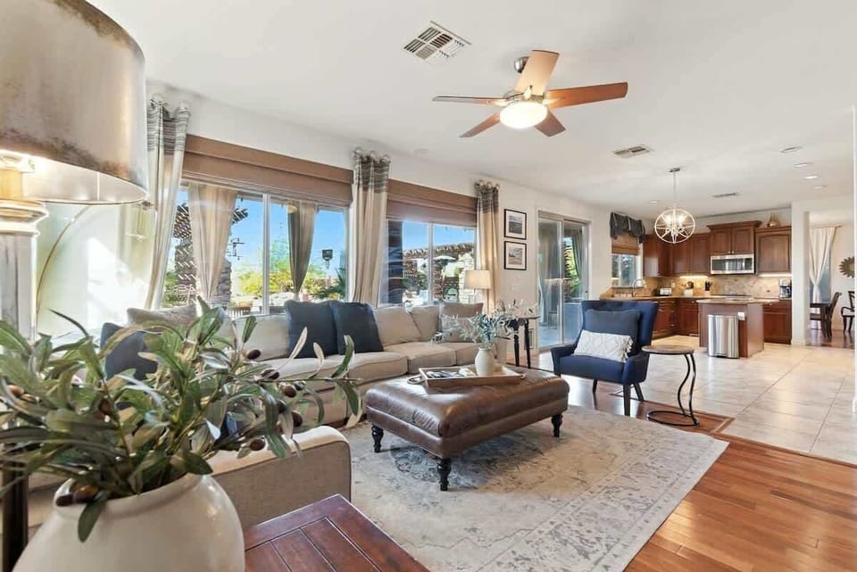 Bright open floor secondary living area with lounging areas, featuring a smart TV, electric fireplace, and connected to the kitchen area. (1st Floor)