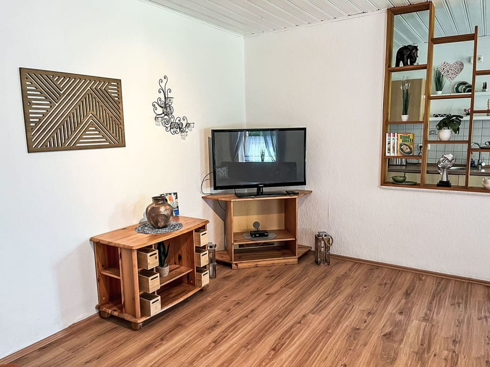 Flooring, Furniture, Wood, Wood Flooring, Floor, Interior Design, Electronic Device, Laminate Flooring, Room, Living Room