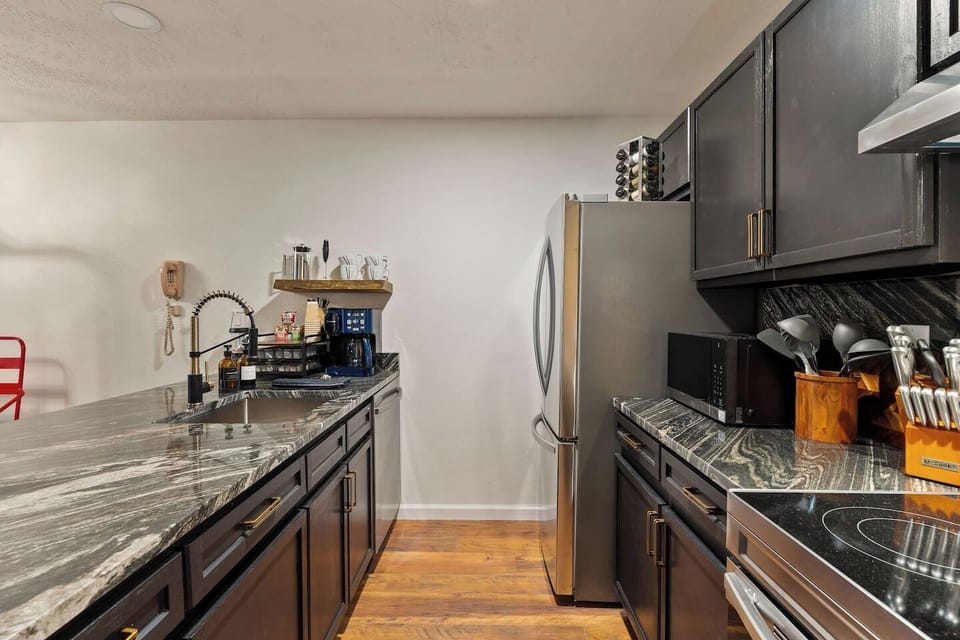  Fill your mug again at the counter coffee station while the fridge stays stocked with everything you grabbed on the way in this galley layout keeps cooking simple for four.