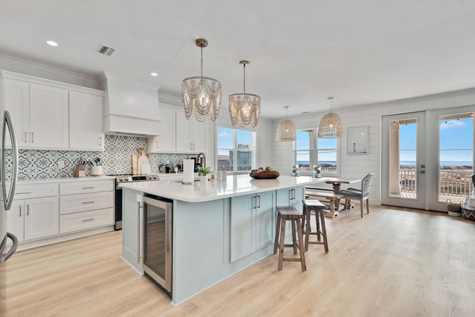 Plenty of storage, additional beverage fridge built into the massive island, and six bar stools for seating.