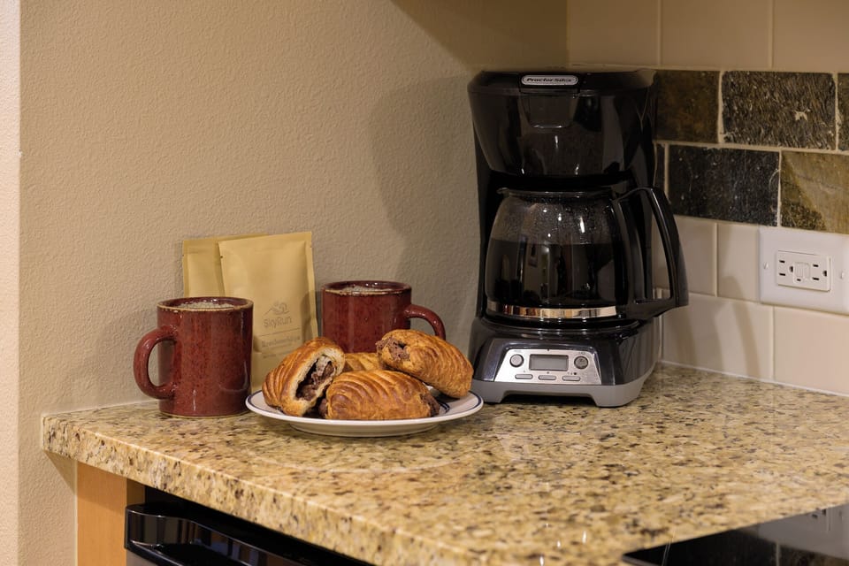 - Start your mornings right with a fresh brew from the drip coffee maker and cozy mugs - Enjoy pastries and peaceful vibes on granite counters before your next adventure - Coffee, tea, and treats await you in this warm, welcoming kitchen corner