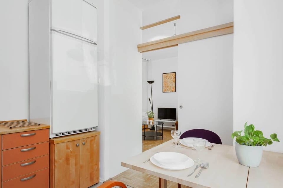 A kitchen with bright orange cabinets, offering a functional and colorful cooking area.