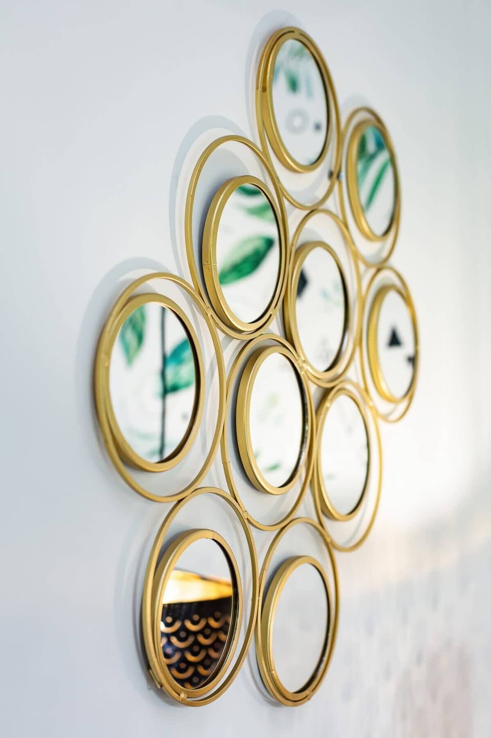 A decorative wall piece made up of circular mirrors, adding an artistic touch to the space.