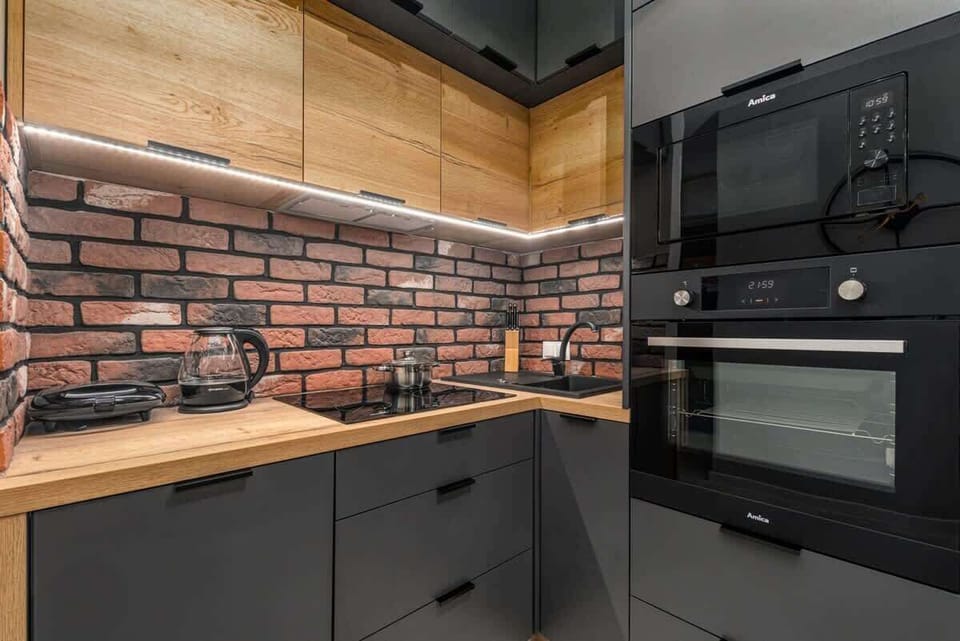 Kitchenette with oven and refrigerator. 