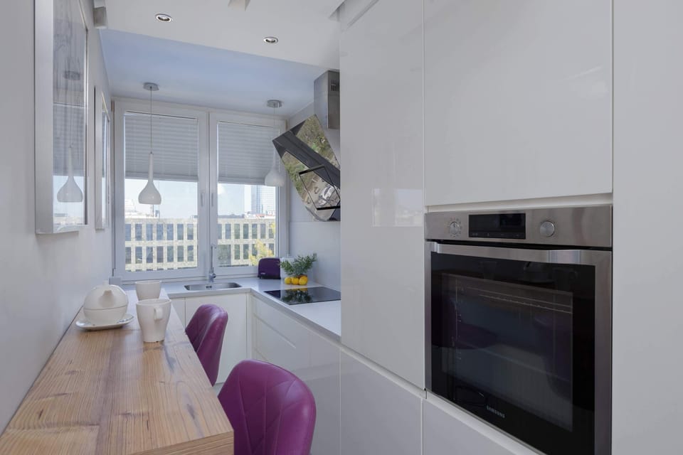 Bright kitchen with oven, induction hob and high table for two.