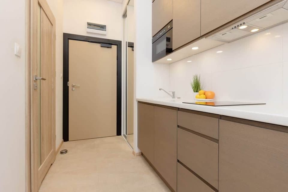 A functional kitchenette with sleek cabinetry, a built-in stove, and contemporary finishes.

