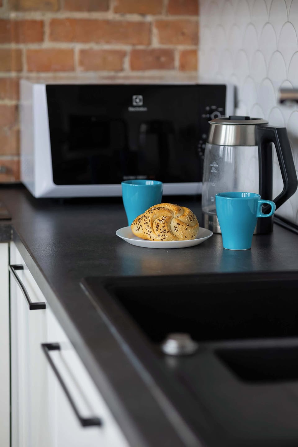 A coffee corner in the kitchen featuring a coffee maker and cup. A cozy touch for early mornings.