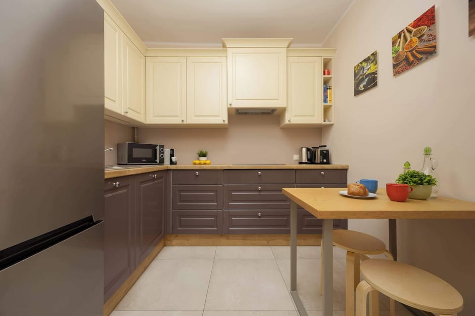 Kitchenette with a small dining table and colorful wall art.
