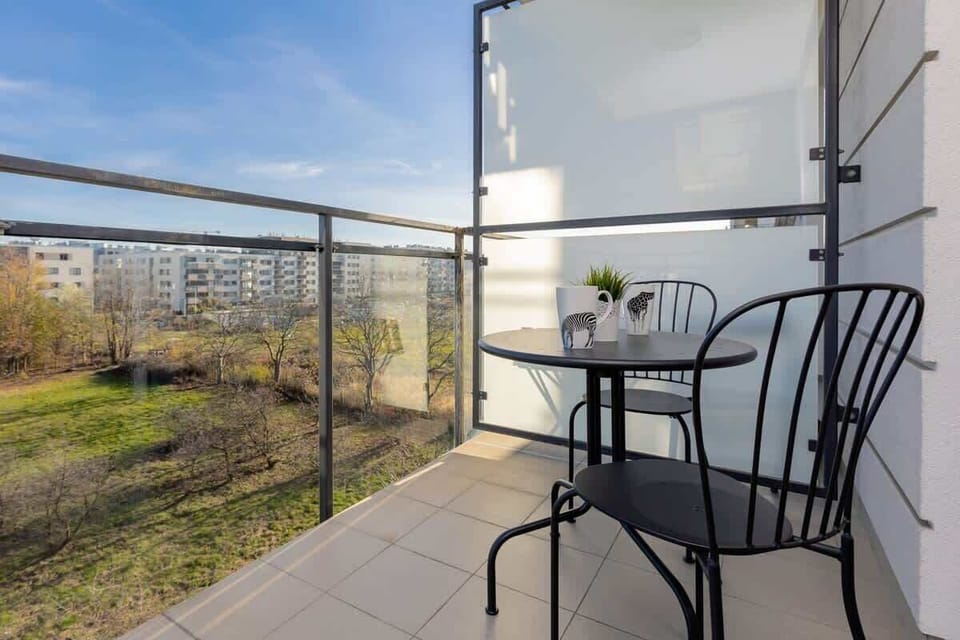 Private balcony with seating and open view of the surroundings.