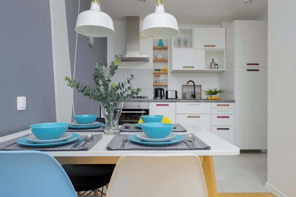 Fully equipped kitchenette with gas stove and dining area.