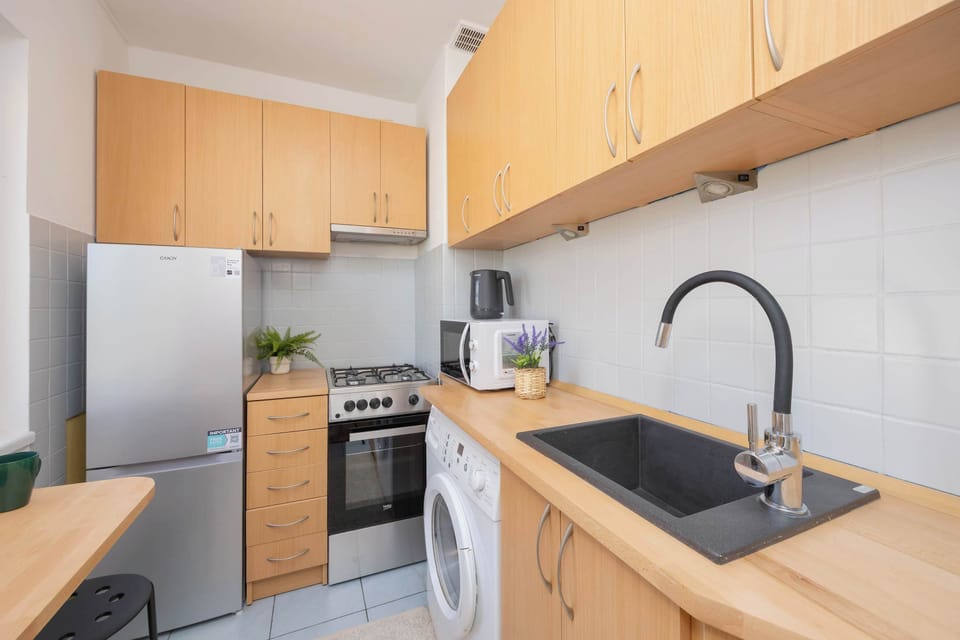 Wooden countertops and light cabinetry bring warmth and a natural touch.