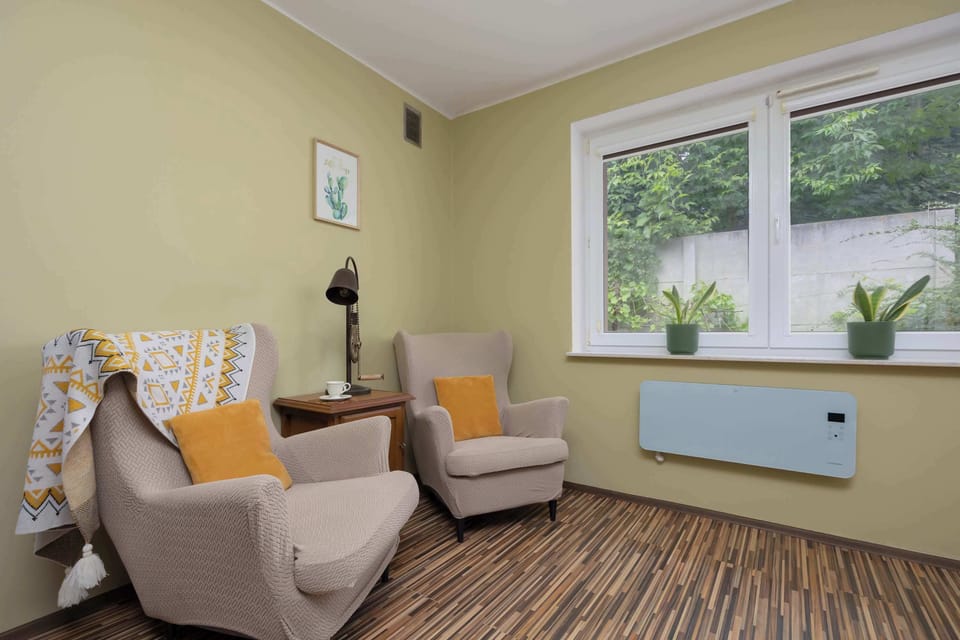 Cozy living room with bookshelves and two armchairs.