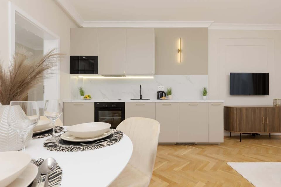 A different angle of the kitchen, highlighting the elegant beige cabinets and under-cabinet lighting.
